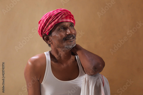 Smiling farmer looking up	 photo