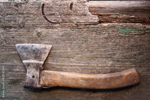 Forestry. Metal sharpen axe tool on the old wooden desk. Rural life in the farm