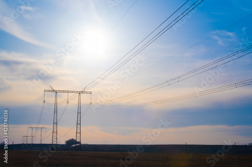 Electric high voltage pole at sunset background