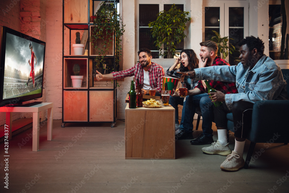 Naklejka premium Group of friends watching TV, sport match together. Emotional fans cheering for favourite team, watching on exciting game. Concept of friendship, leisure activity, emotions