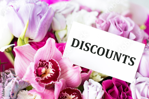 text discounts on the card against the background of flowers