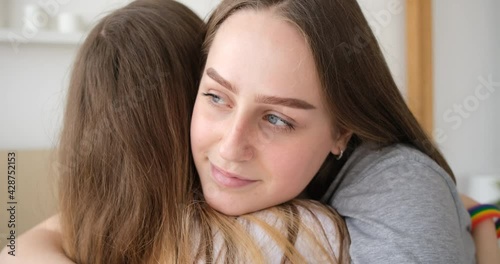Homosexual couple of free happy women hugging and love each other