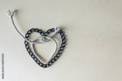 The chain is laid out in the shape of a heart. The concept of a problem relationship, dependence on a partner.