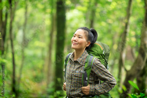 Woman backpacker hiking in spring forest