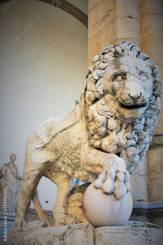 Florence, Tuscany, Italy: ancient statue of a lion in Piazza della Signoria, sculpture that depicts a lion with a sphere under one paw