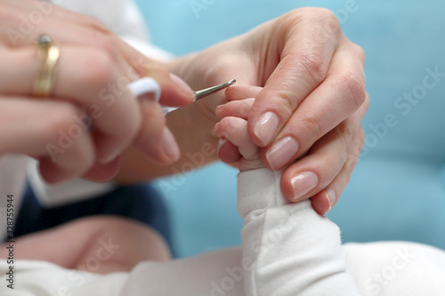 Cutting baby s nails. Baby care  mom cuts her nails.