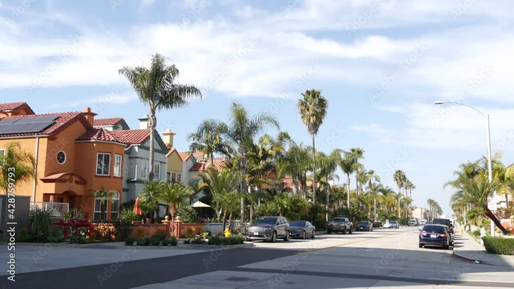 California typical suburban street, tropical Oceanside USA. Different colorful houses row. Generic american homes, buildings facade, townhouse exterior architecture. Residential district real estate. California typical suburban street, tropical Oceanside USA. Different colorful houses row. Generic american homes, buildings facade, townhouse exterior architecture. Residential district real estate.