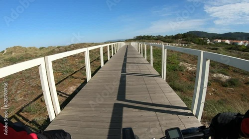 Esposende, Portugal, April 18, 2021:  POV SLOW MOTION of biker riding bike. First Person View of a man cycling in the Ecovia Litoral Norte (North Coast Ecoway), walking or cycling path. photo