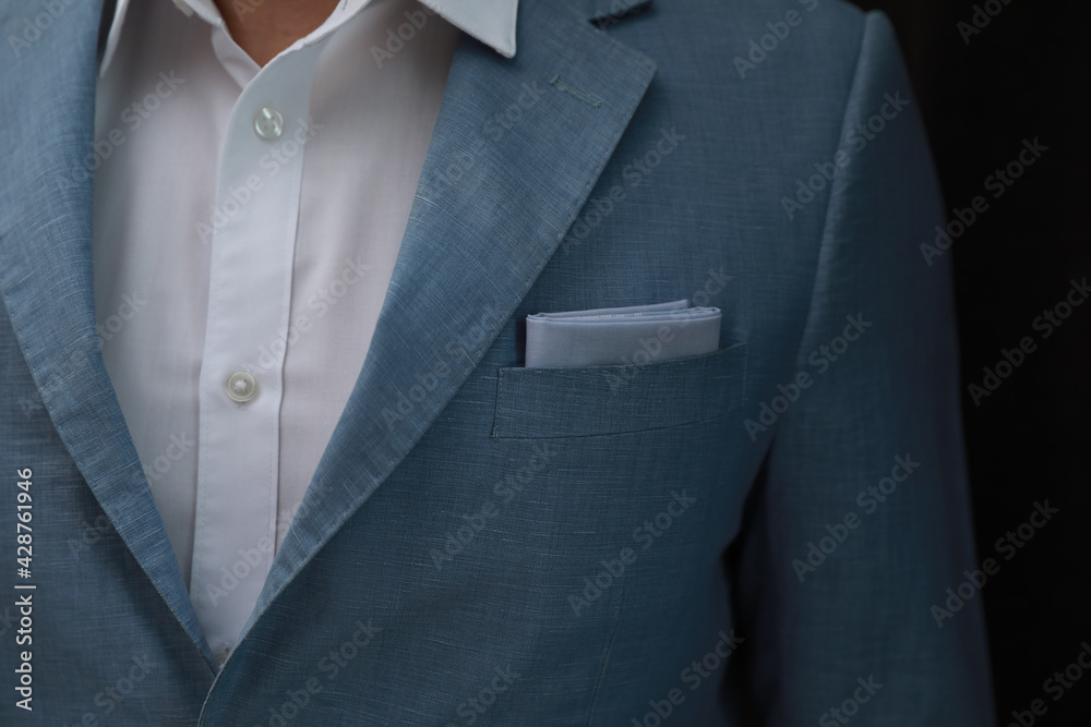Man with handkerchief in suit pocket on black background, closeup Man with handkerchief in suit pocket on black background, closeup