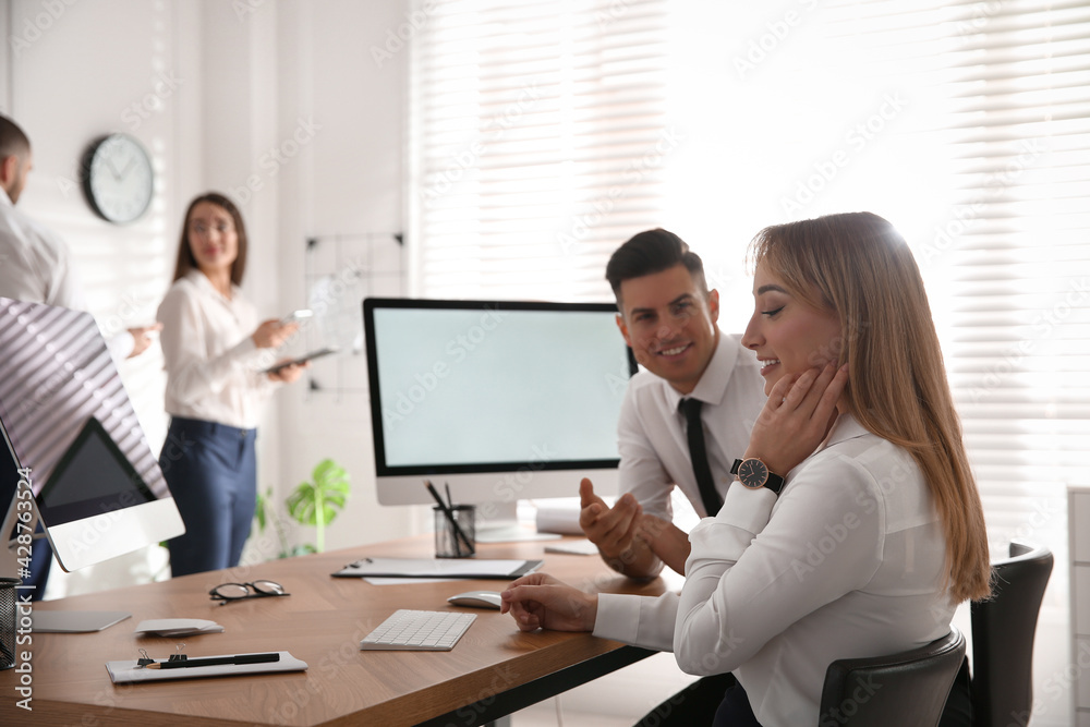 Man flirting with his colleague during work in office Man flirting with his colleague during work in office