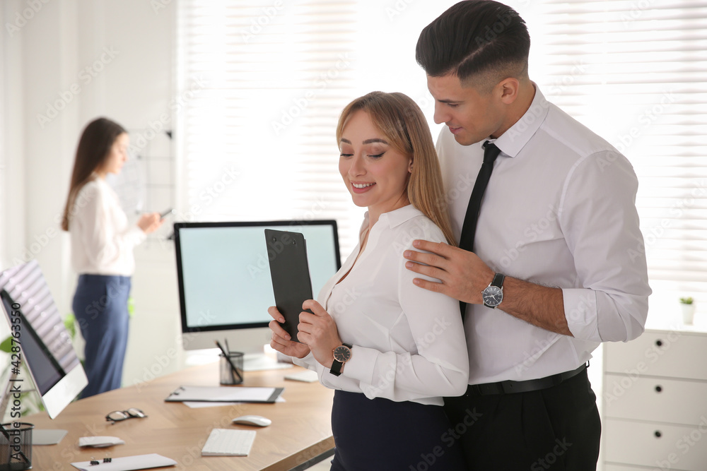 Man flirting with his colleague in office. Space for text Man flirting with his colleague in office. Space for text