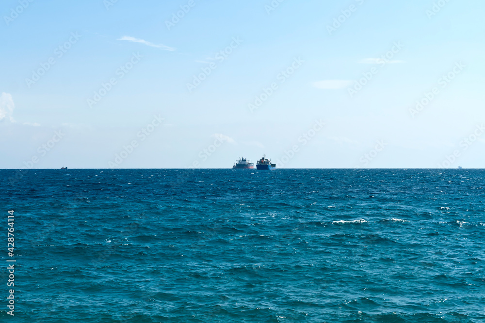 Sea, sky and ships on the horizon