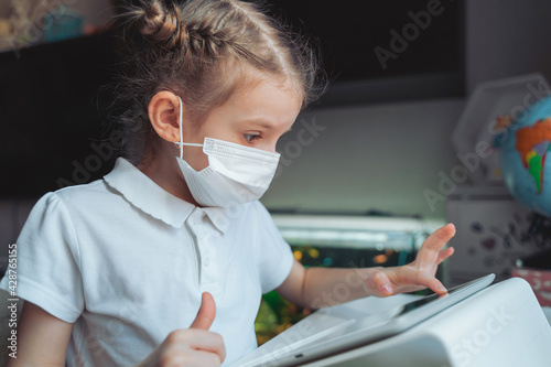 Caucasian preteen girl with medical mask on her face concentrate