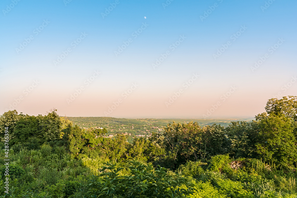 Panorama of village and surrounding hills with clear sky