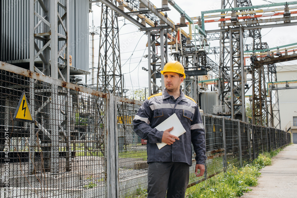 The energy engineer inspects the equipment of the substation. Power engineering. Industry The energy engineer inspects the equipment of the substation. Power engineering. Industry