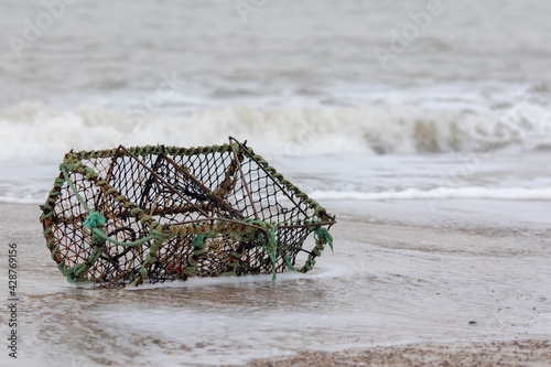 Lobster creel washed up on the beach. Crab pot fishing basket.