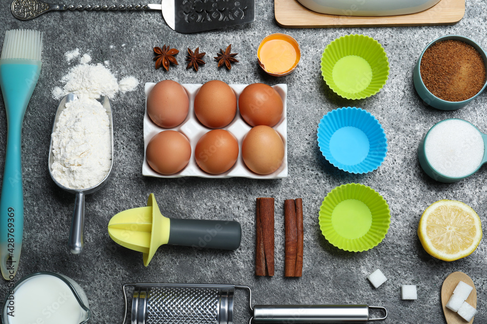 Cooking utensils and ingredients on grey table, flat lay Cooking utensils and ingredients on grey table, flat lay