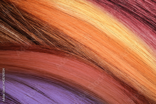 Strands of different color hair as background  closeup