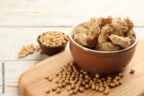 Dehydrated soy meat chunks and beans on white wooden table
