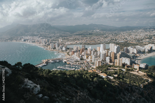 Scenic view of a calm sea with the cityscape seen from a mountainin Calpe Island, Spain photo