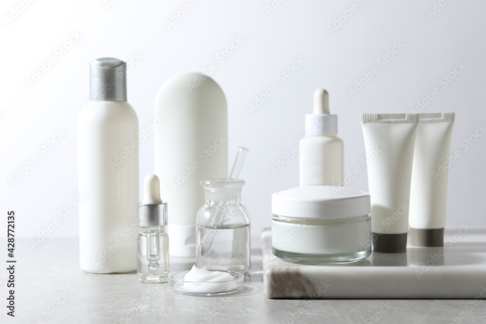 Organic cosmetic products and laboratory glassware on white table - obrazy, fototapety, plakaty 