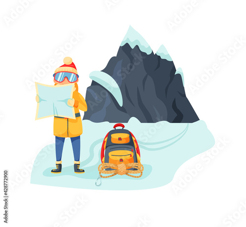 Mountaineer reading map at snowy mount range foot