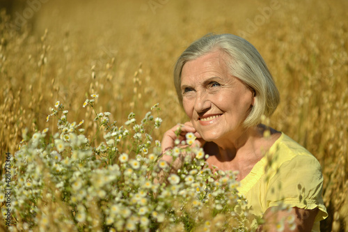 Happy senior woman with flowers