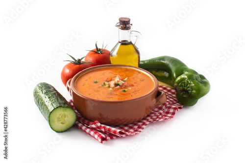 Gazpacho soup in crock pot and ingredients isolated on white background