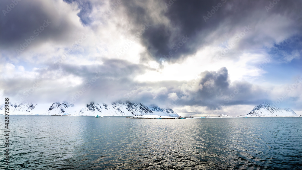 Svalbard panorama of snow covered mountains with low cloud