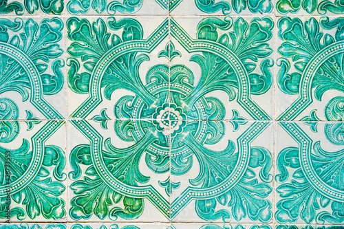 Closeup of traditional vintage ceramic glazed tiles (azulejo) on the walls of Lisbon, Portugal in green colors