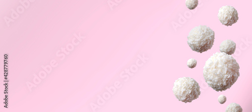 White sweet candy balls against pink background.Empty space photo