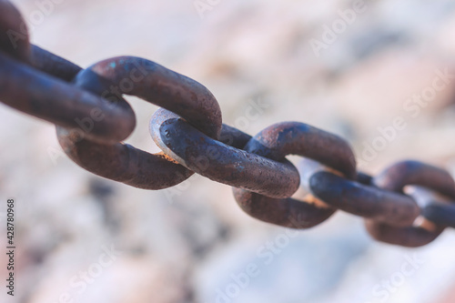 Heavy cast iron chain with rust. Protective fence on the bank of the Neva River in St. Petersburg.