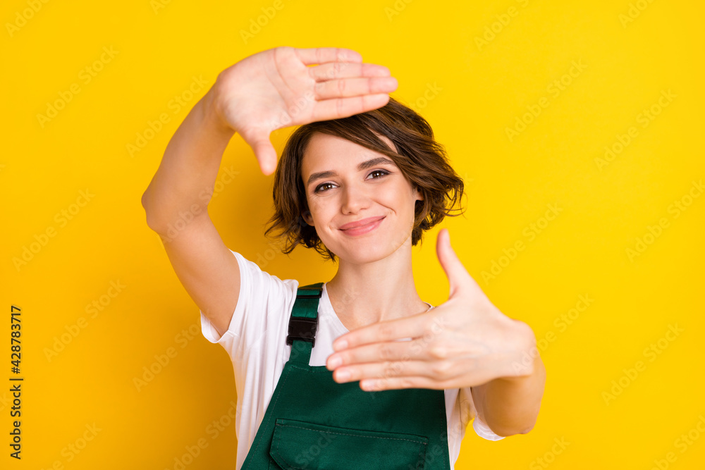 Photo of optimistic nice brown hair lady hands shot wear uniform isolated on yellow background Photo of optimistic nice brown hair lady hands shot wear uniform isolated on yellow background