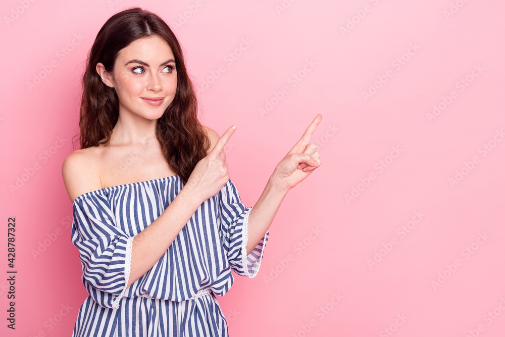 Photo of nice optimistic brunette lady point empty space wear blue dress isolated on pastel pink color background Photo of nice optimistic brunette lady point empty space wear blue dress isolated on pastel pink color background