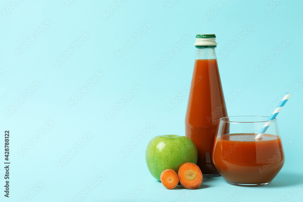 Bottle and glass of juice and ingredients on blue background Bottle and glass of juice and ingredients on blue background