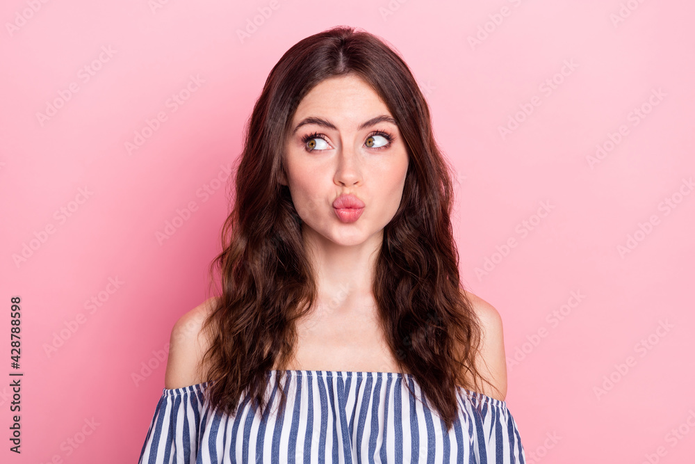 Photo of nice optimistic brunette lady look empty space blow kiss wear blue dress isolated on pink color background Photo of nice optimistic brunette lady look empty space blow kiss wear blue dress isolated on pink color background