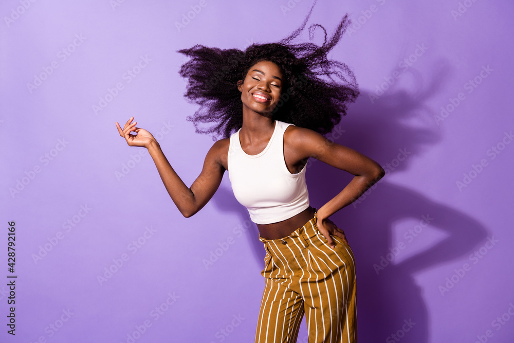 Portrait of charming dreamy cheerful girl dancing rest posing having fun isolated over bright violet purple color background