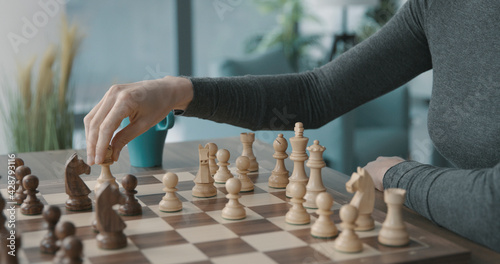 Woman playing chess at home