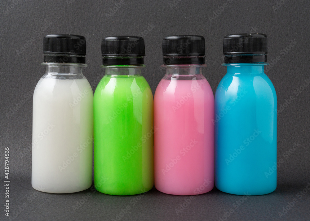 Colorful liquid in a bottles on black background. Colorful liquid in a bottles on black background.