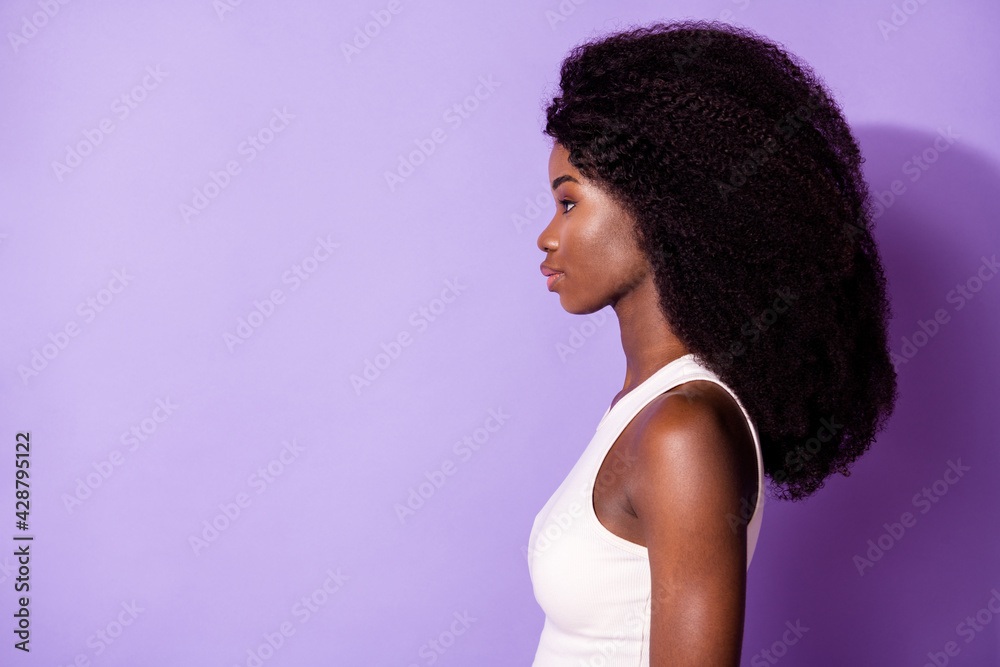Profile photo of wavy hairdo concentrated dark skin person look empty space isolated on violet color background Profile photo of wavy hairdo concentrated dark skin person look empty space isolated on violet color background