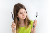 Girl with knife and fork isolated on the white background