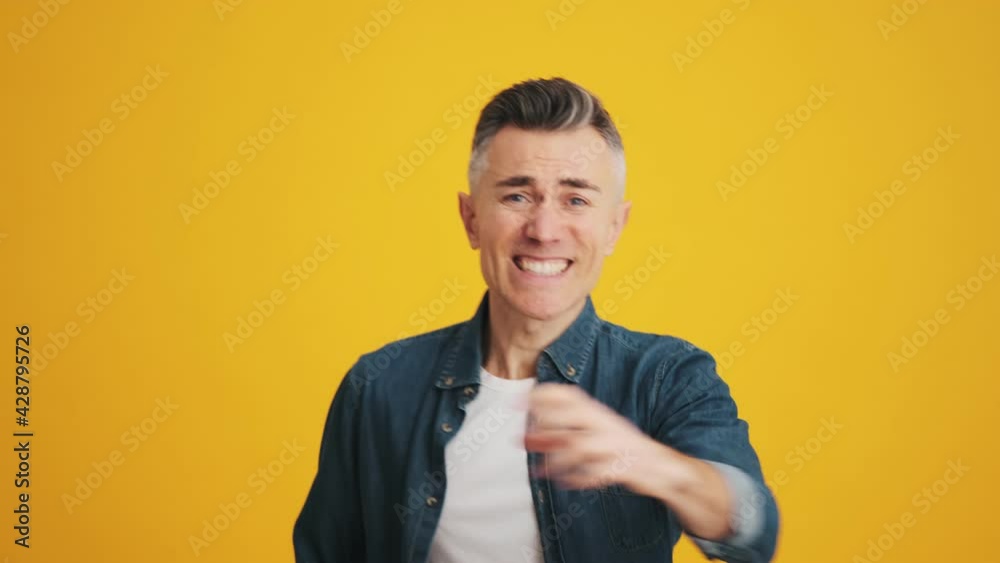 A mature man hoping to win then rejoicing at victory in the studio A mature man hoping to win then rejoicing at victory in the studio