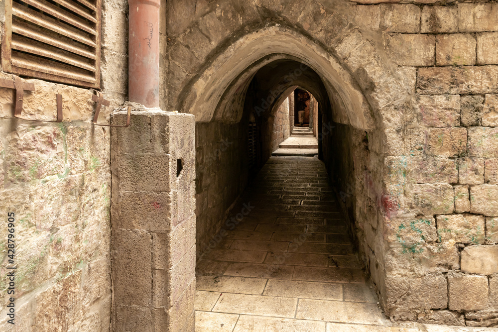 Fototapeta premium Tunnel passage under residential buildings in the Muslim quarter near the exit from the Temple Mount - Chain Gate, in the old city of Jerusalem, in Israel