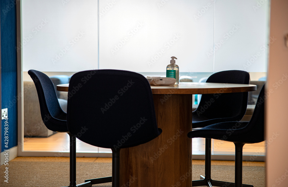 Office in times of covid - hand sanitizer and tissues at the meeting table Office in times of covid - hand sanitizer and tissues at the meeting table