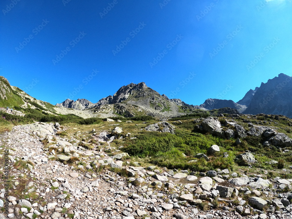 Rocky mountain towering up the valley beneath it like the guardian of the nature. Rocky mountain towering up the valley beneath it like the guardian of the nature.