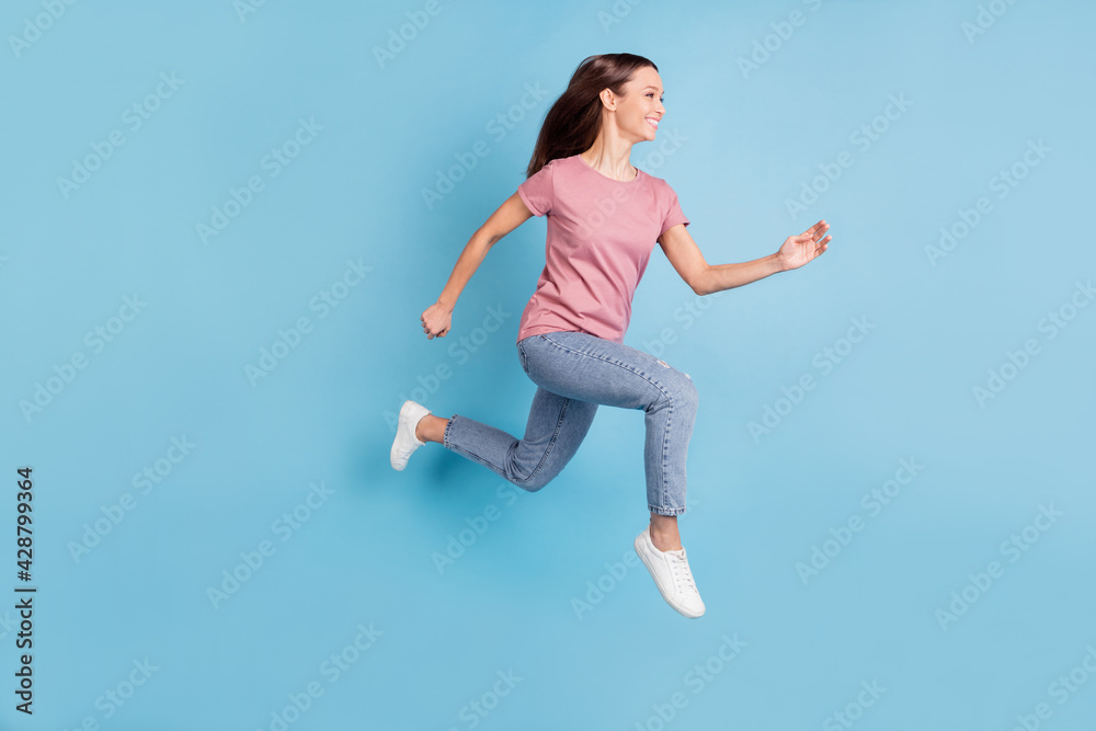 Full body profile side photo of excited positive young lady jump up run sale isolated on blue color background