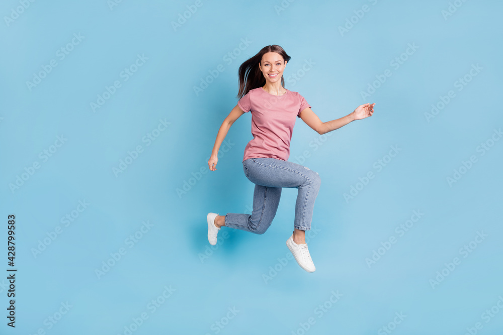Full body profile side photo of stunning happy young woman jump up run isolated on blue color background