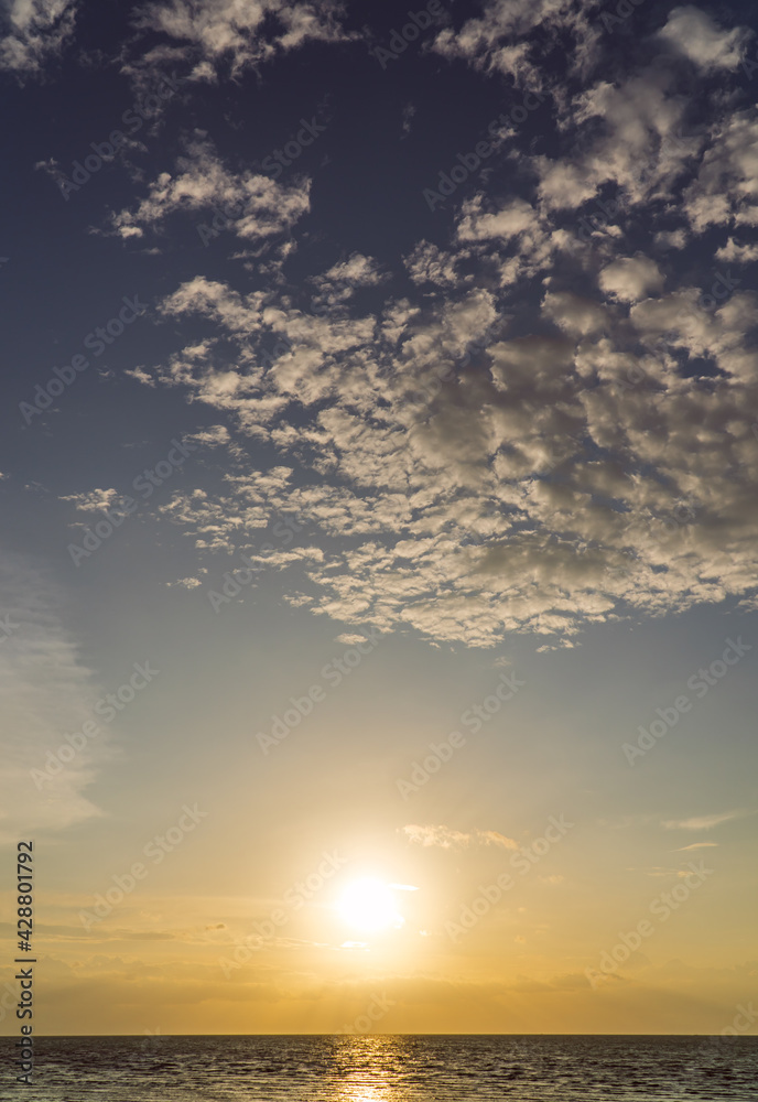 Sunset sky vertical over sea in the evening with colorful orange sunlight, Dusk sky background.