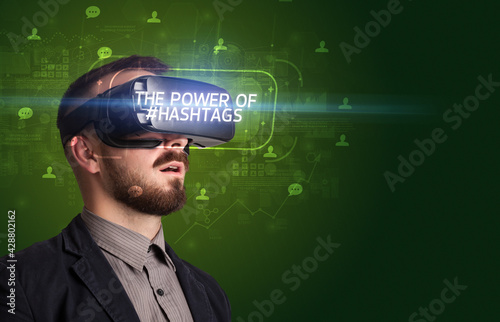Businessman looking through Virtual Reality glasses, social media concept concept