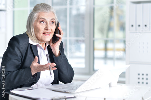 senior woman in formal wear working in office © aletia2011